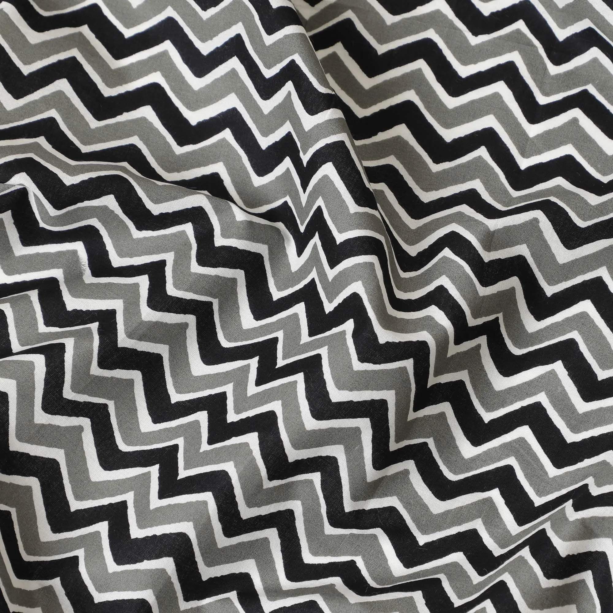 White organic cotton fabric with black, off white and sage green screen block print in abstract design-D10286